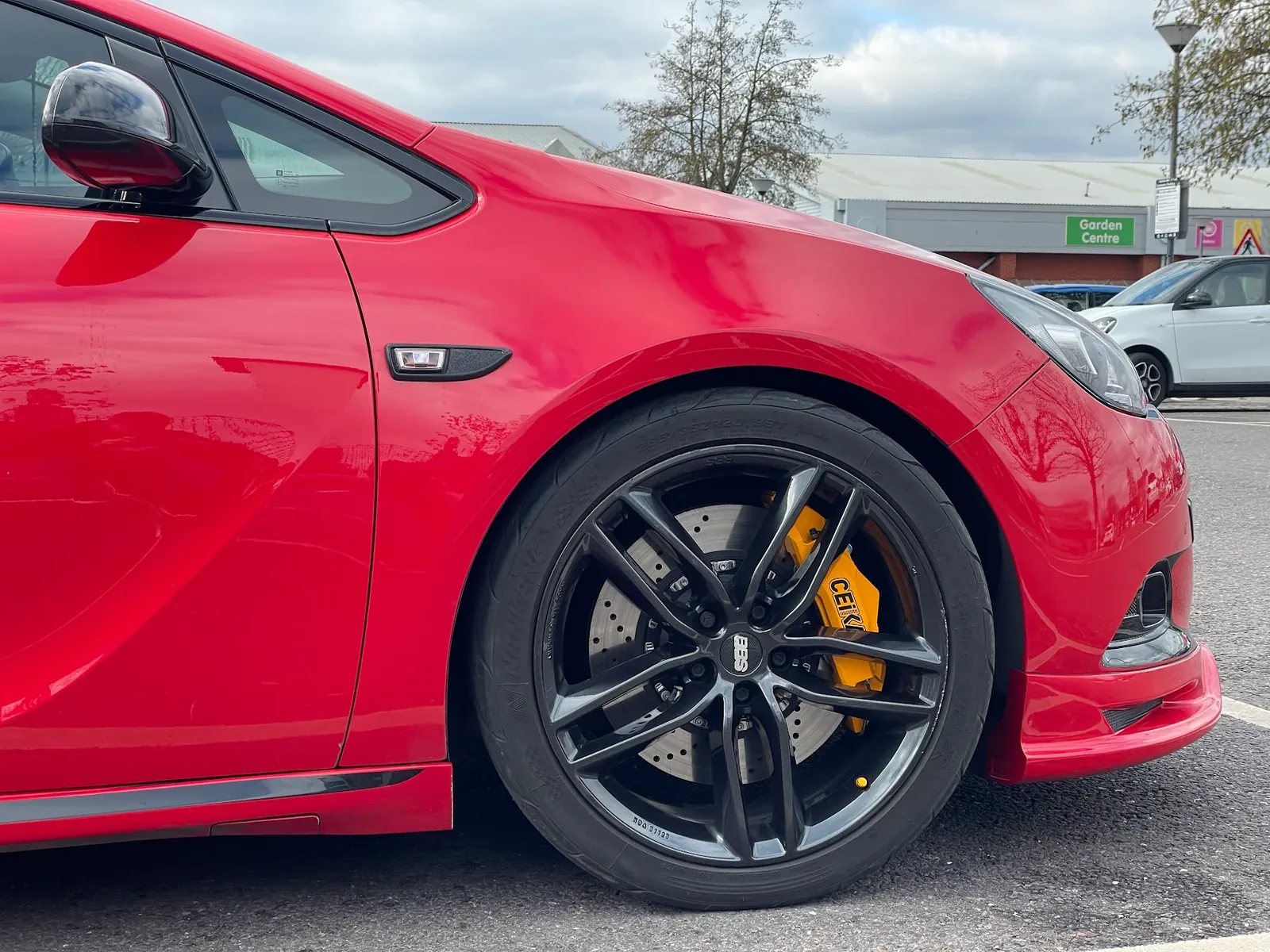 Red Astra VXR with black alloys and yellow brake calipers