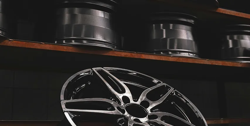 Alloy wheels on a workshop shelf